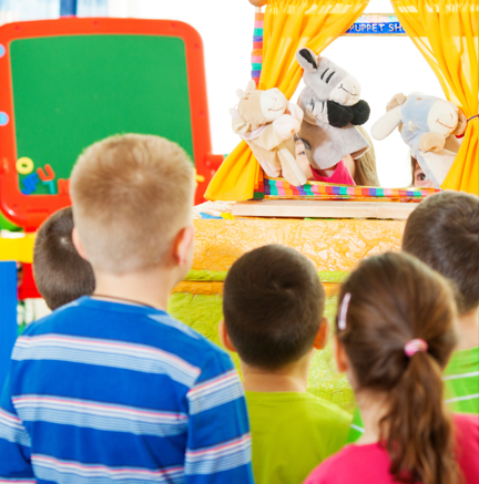 enfants de dos devant marionnettes