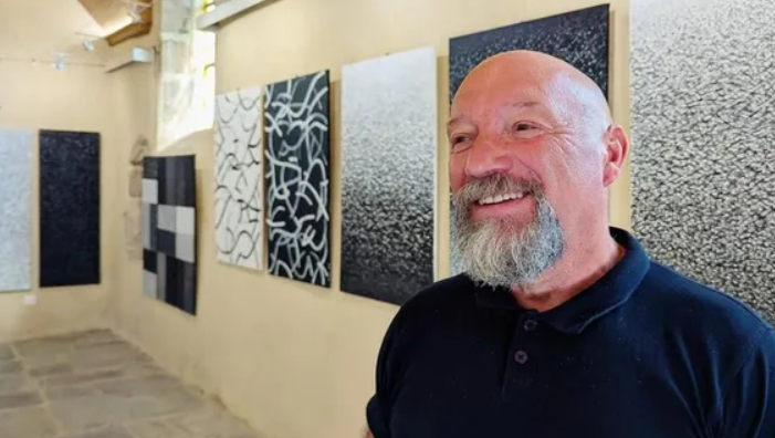 portrait de Denez devant des peintures noir te blanc